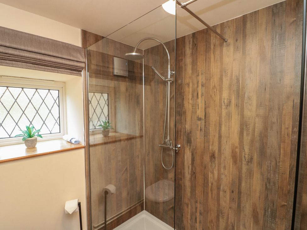 A shower area with glass panel and toilet at Foxhunter Cottage Hawsker near Whitby and Robin Hood's Bay