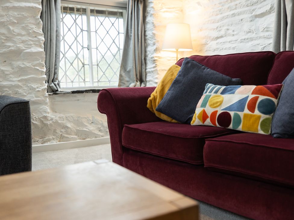 A living room with a sofa and cushions at The Coach House in Llangollen