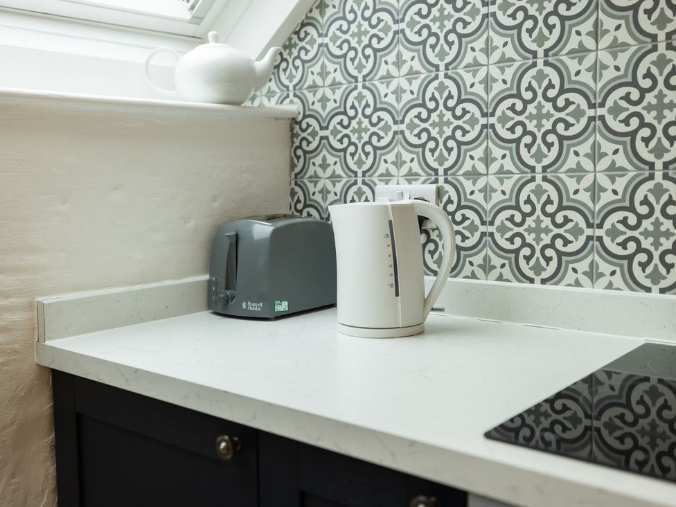 A kitchen with a kettle and toaster on the countertop at The Coach House Llangollen