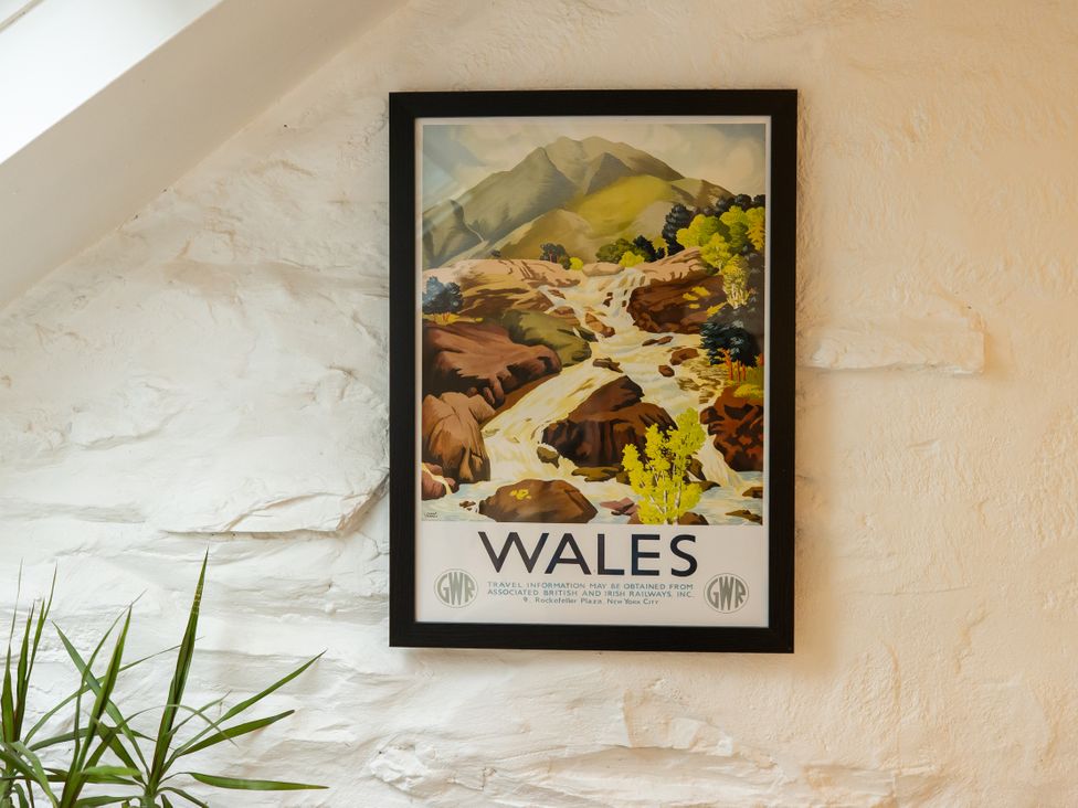 A poster of Wales featuring mountains and a river at The Coach House in Llangollen