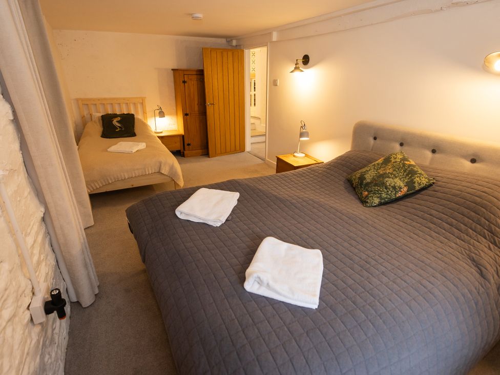 A bedroom with a double bed and a single bed at The Coach House in Llangollen