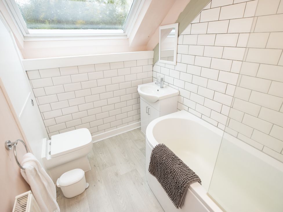 A bathroom with a sink and bathtub at The Coach House in Llangollen