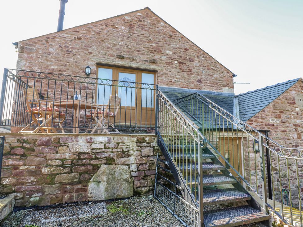 An outdoor area with a table and chairs at Apple Tree Cottage Bleatarn near Kirkby Stephen