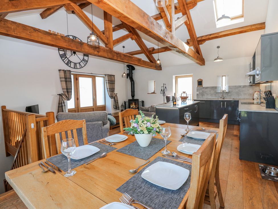 A dining room with a table set for meals at Apple Tree Cottage Bleatarn near Kirkby Stephen