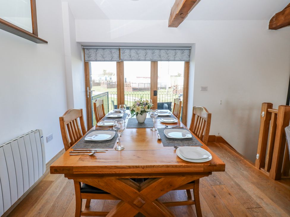 A dining room with table set for meals at Apple Tree Cottage Bleatarn near Kirkby Stephen