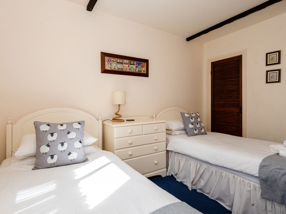 A bedroom with two single beds and a dresser at Blueberry Cottage in Akeld near Wooler