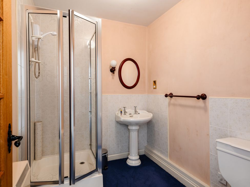 A bathroom with shower, sink, and toilet at Blueberry Cottage Akeld near Wooler