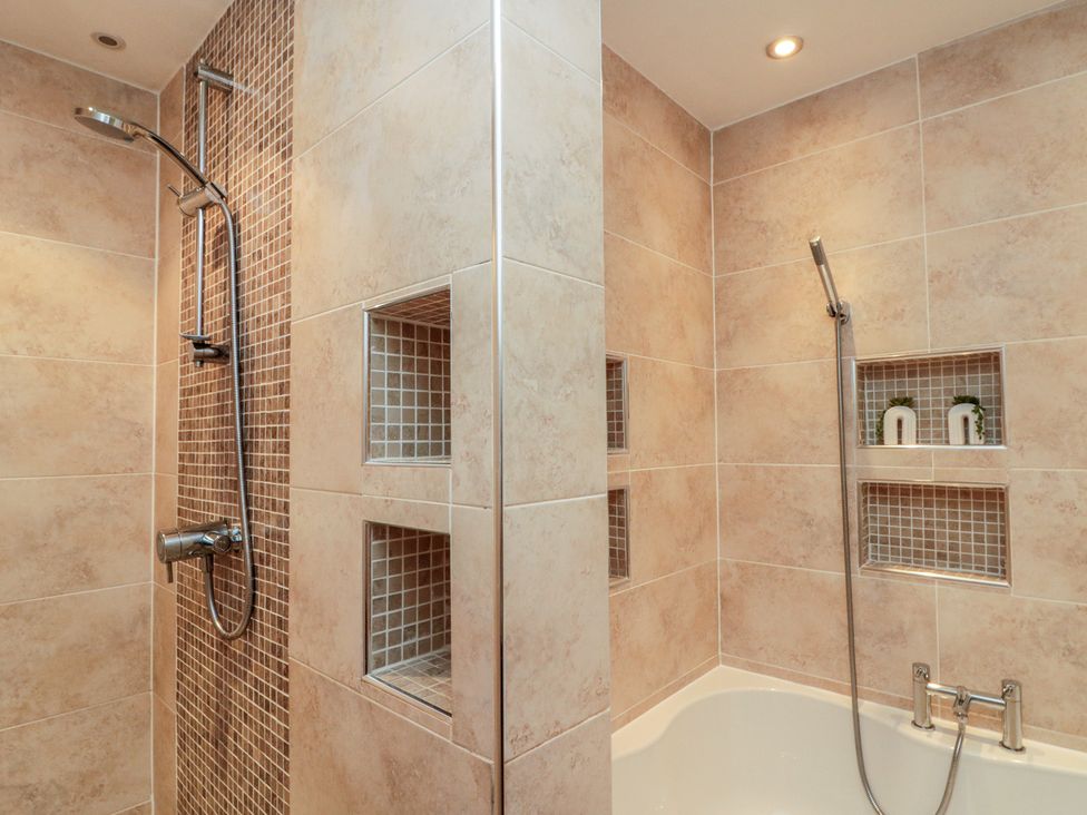 A bathroom with a shower and bath at Apartment 6 in Whitby