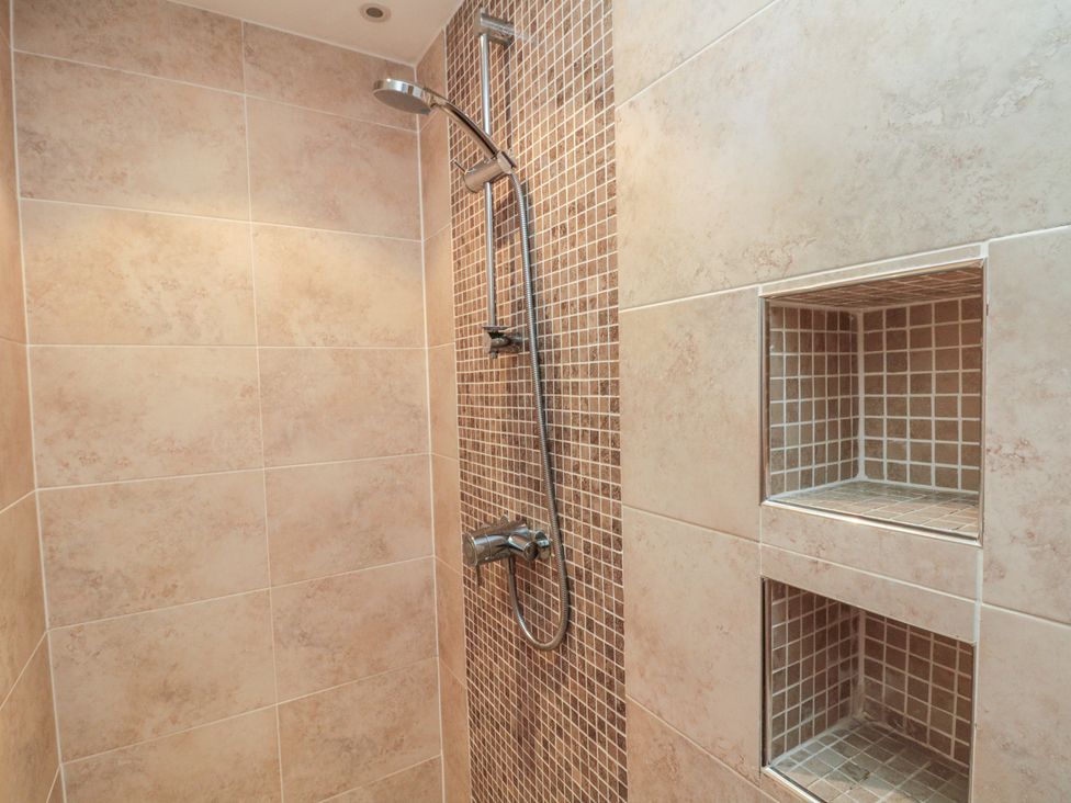 A shower with tiles and niches at Apartment 6 in Whitby