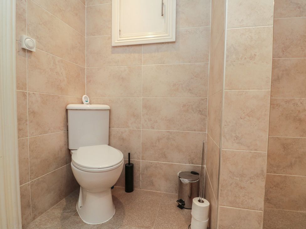 A bathroom with a toilet and accessories at Apartment 6 in Whitby