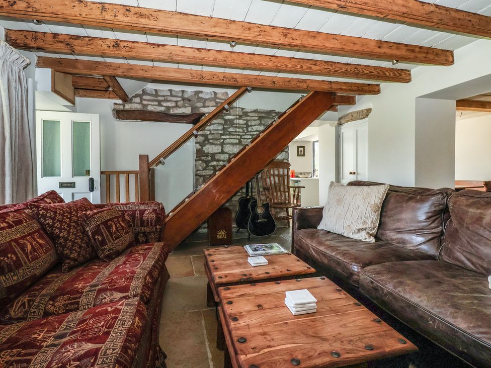 A living room with a sofa and guitar at Lyndhurst, Carlton-in-Coverdale, near Leyburn