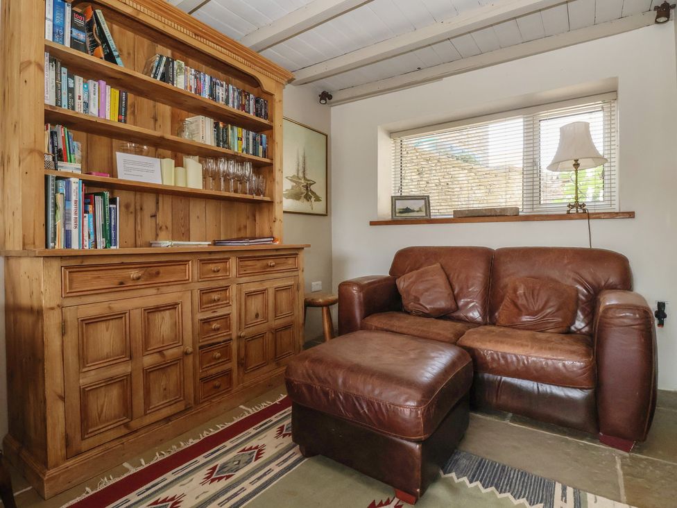 A living room with a bookcase and sofa at Lyndhurst near Carlton-in-Coverdale, near Leyburn