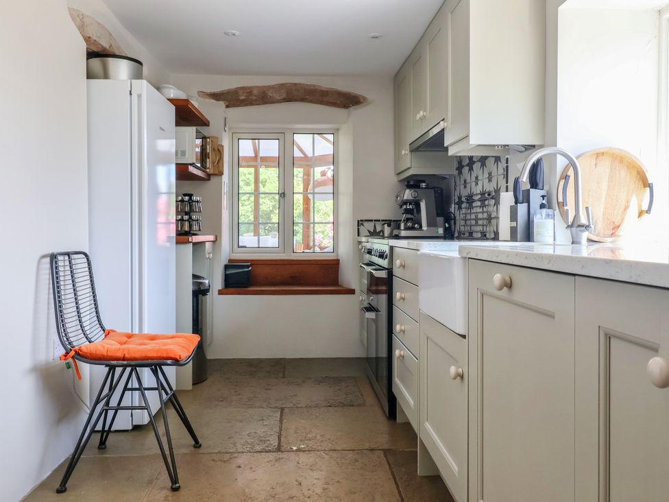 A kitchen with refrigerator, stove, sink and window at Lyndhurst in Carlton-in-Coverdale, near Leyburn