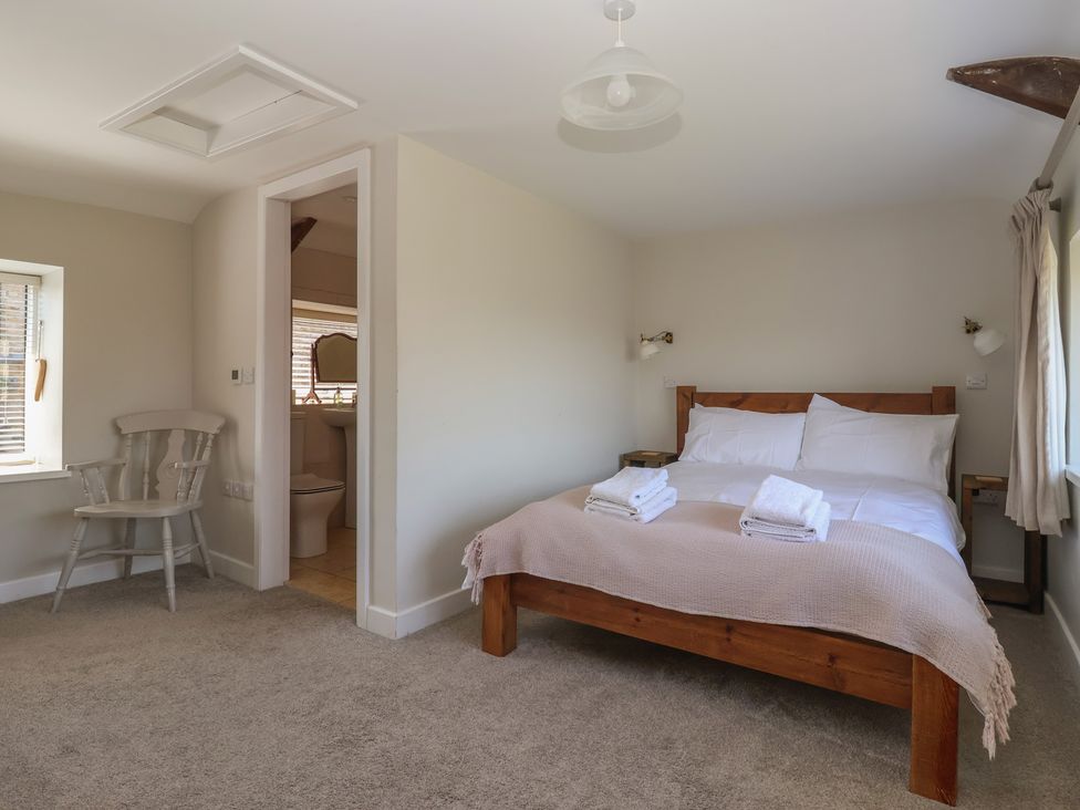 A bedroom with a bed and chair at Lyndhurst in Carlton-in-Coverdale, near Leyburn