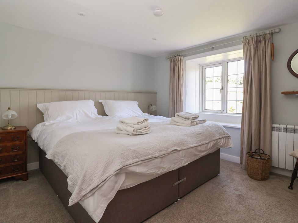 A bedroom with a bed and nightstand at Lyndhurst in Carlton-in-Coverdale, near Leyburn