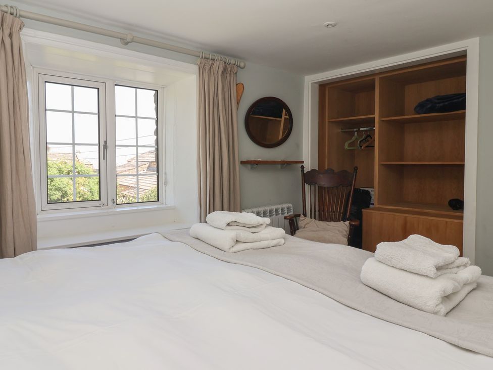 A bedroom with a bed and closet at Lyndhurst in Carlton-in-Coverdale, near Leyburn