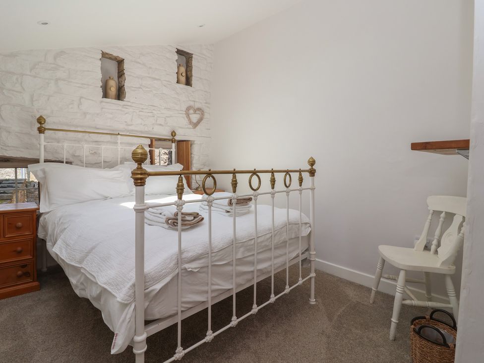A bedroom with a bed and nightstand at Lyndhurst, Carlton-in-Coverdale, near Leyburn