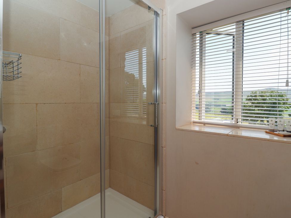 A shower area with a window and shelf at Lyndhurst in Carlton-in-Coverdale, near Leyburn