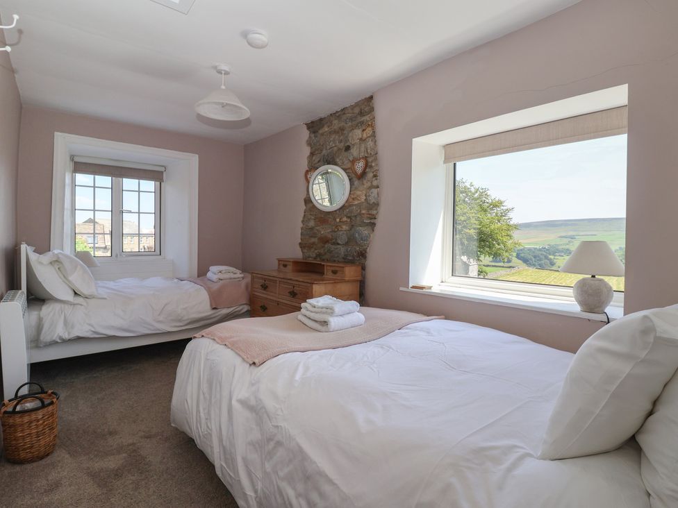 A bedroom with two beds and a dresser at Lyndhurst, Carlton-in-Coverdale, near Leyburn