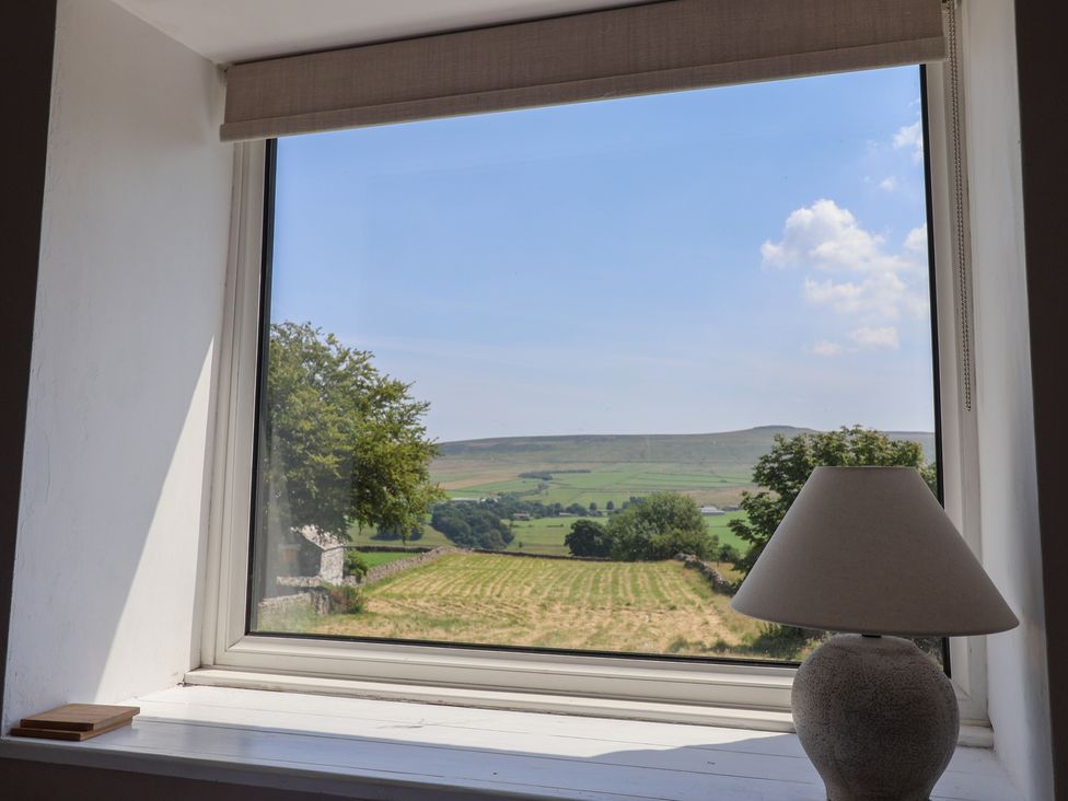 A view of a landscape with a lamp beside the window at Lyndhurst, Carlton-in-Coverdale, near Leyburn