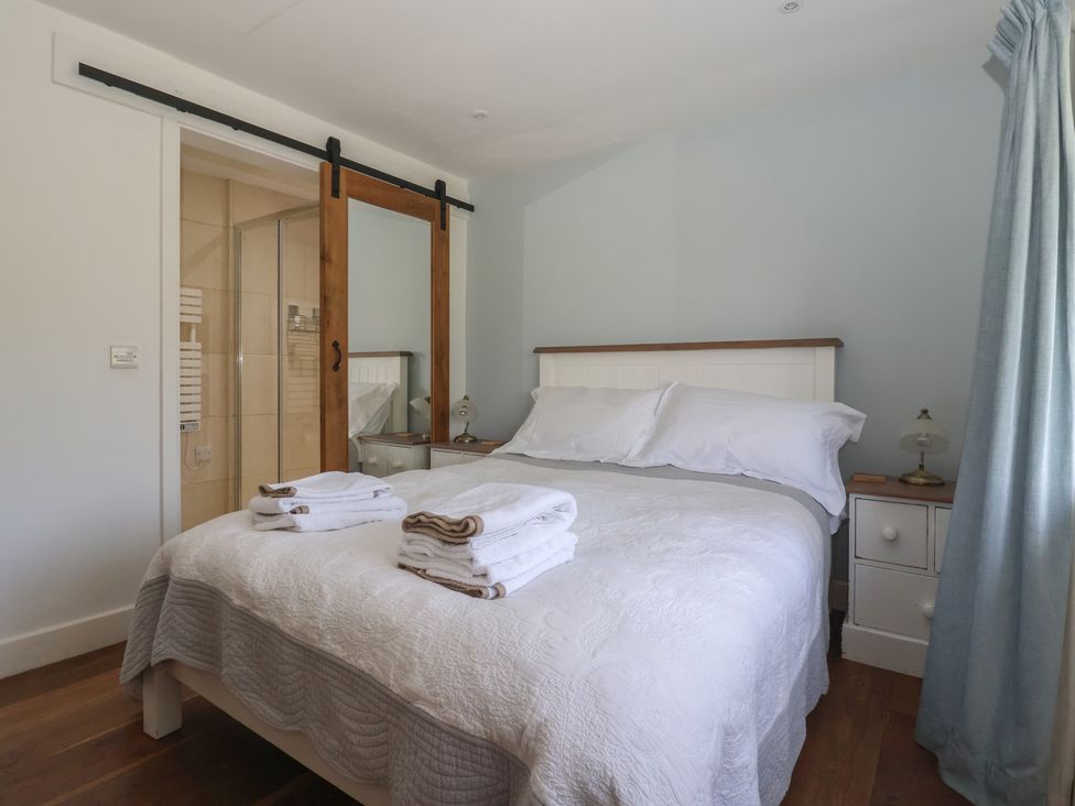 A bedroom with a bed and bedside table at Lyndhurst, Carlton-in-Coverdale, near Leyburn