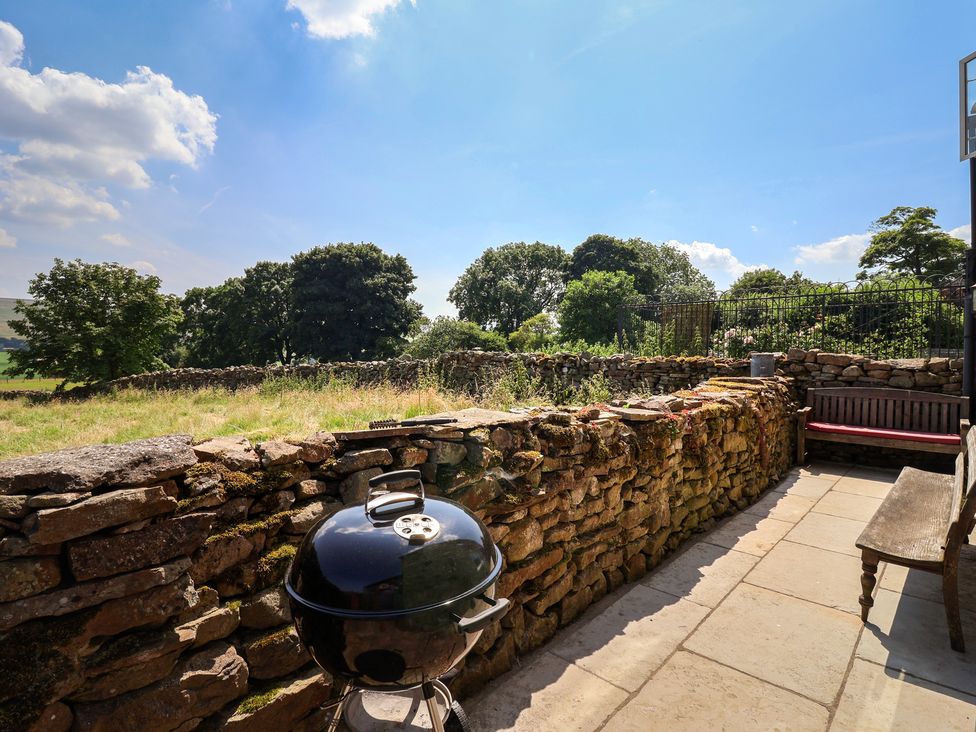 An outdoor area with a barbecue and stone wall at Lyndhurst near Carlton-in-Coverdale, near Leyburn