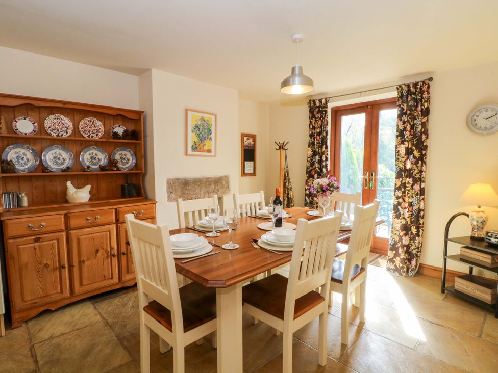 A dining room with a table and chairs at Hurst View Cottage in Biddulph