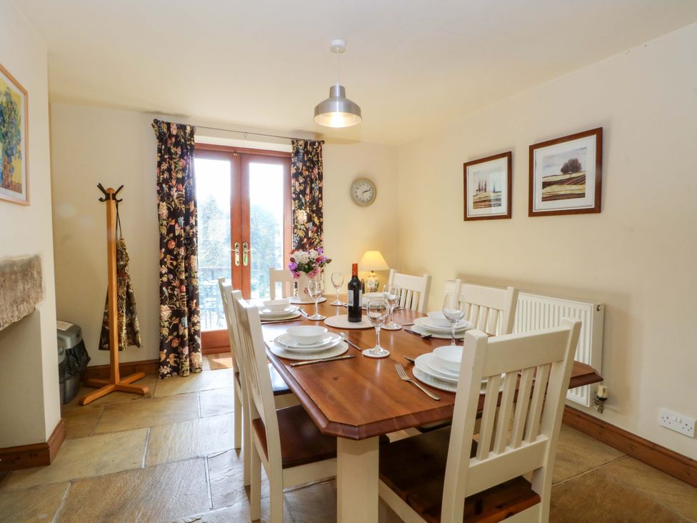 A dining room with a table and chairs at Hurst View Cottage, Biddulph