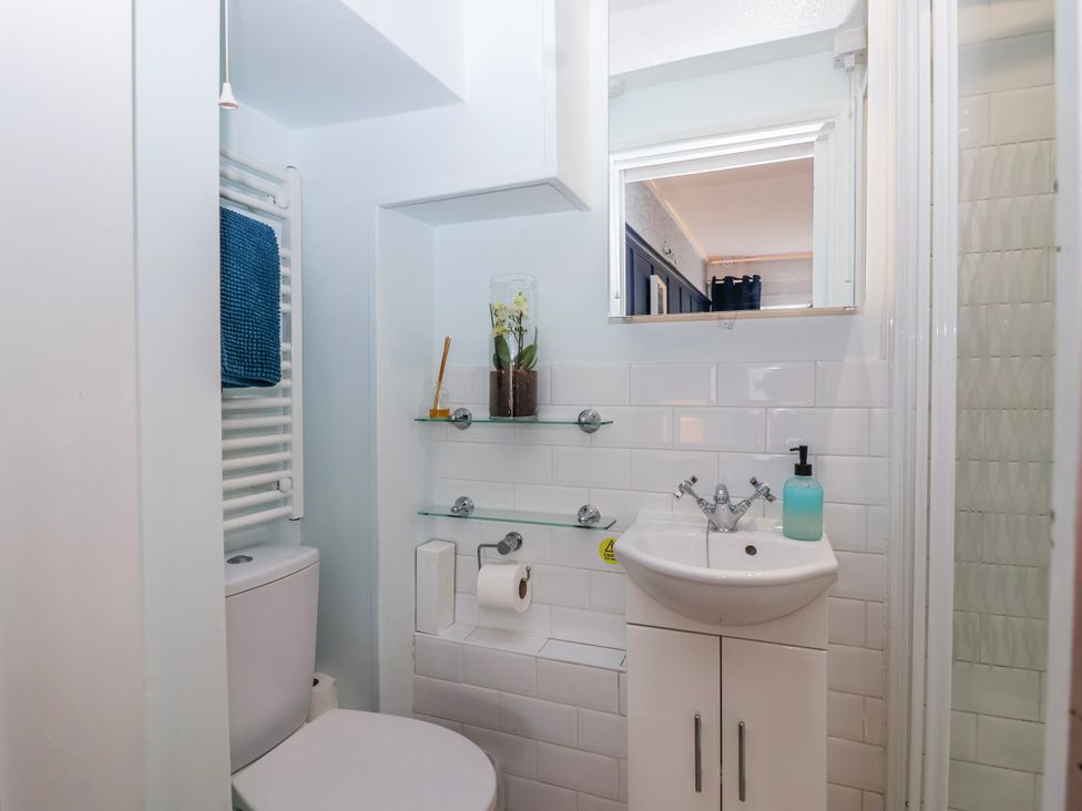 A bathroom with a sink and toilet at Lily Cottage Looe
