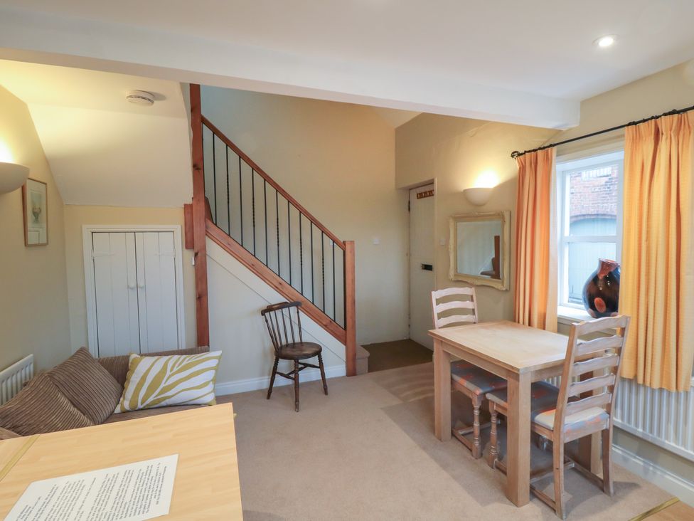 A dining room with a table and chairs at The Old Milk House in 