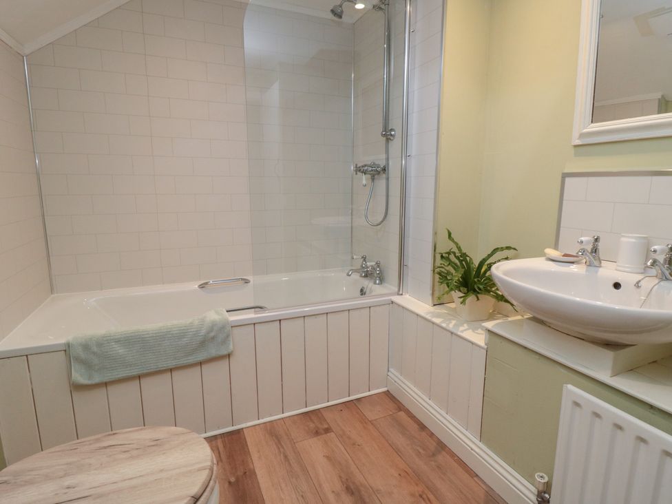 A bathroom featuring a bathtub, shower and sink at The Old Milk House