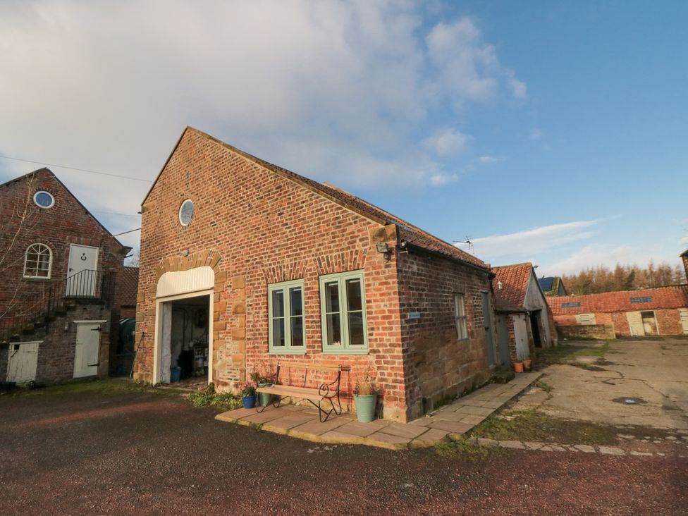 A brick building with windows and a door at The Old Milk House Potto near Hutton Rudby