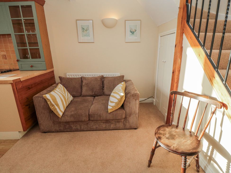 A living room with a sofa and chair at The Old Milk House near Hutton Rudby