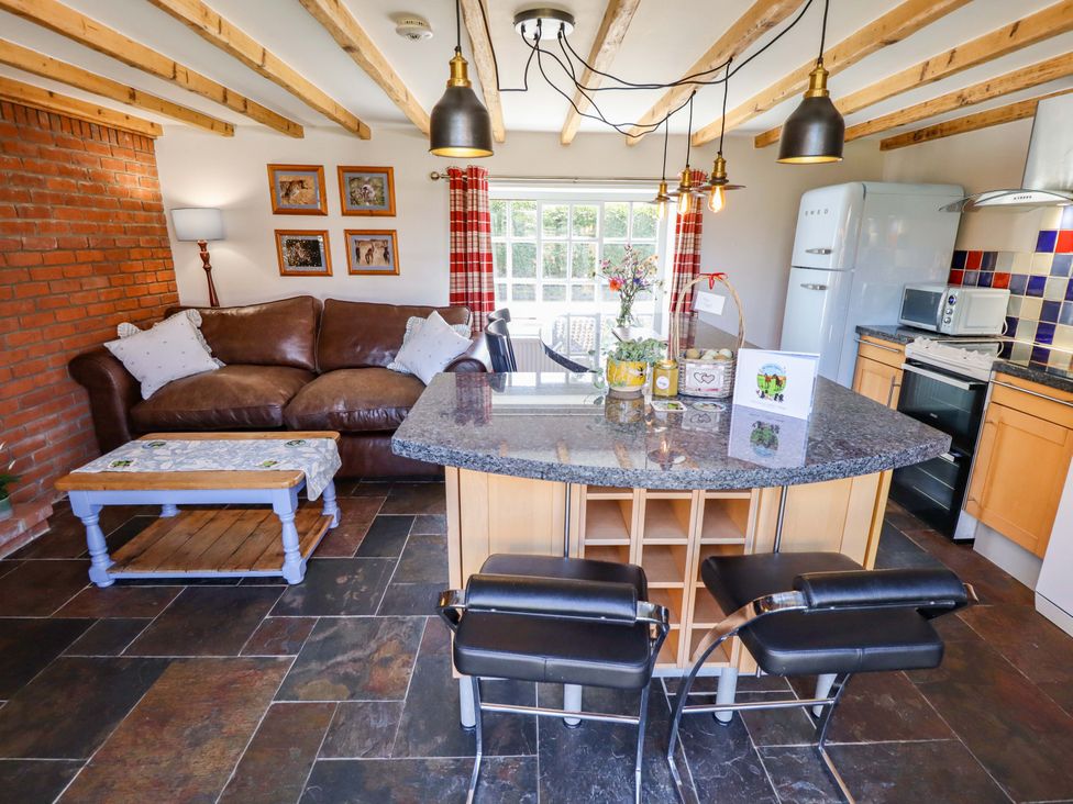A kitchen with a sofa and dining area at Gables Cottage in Market Rasen