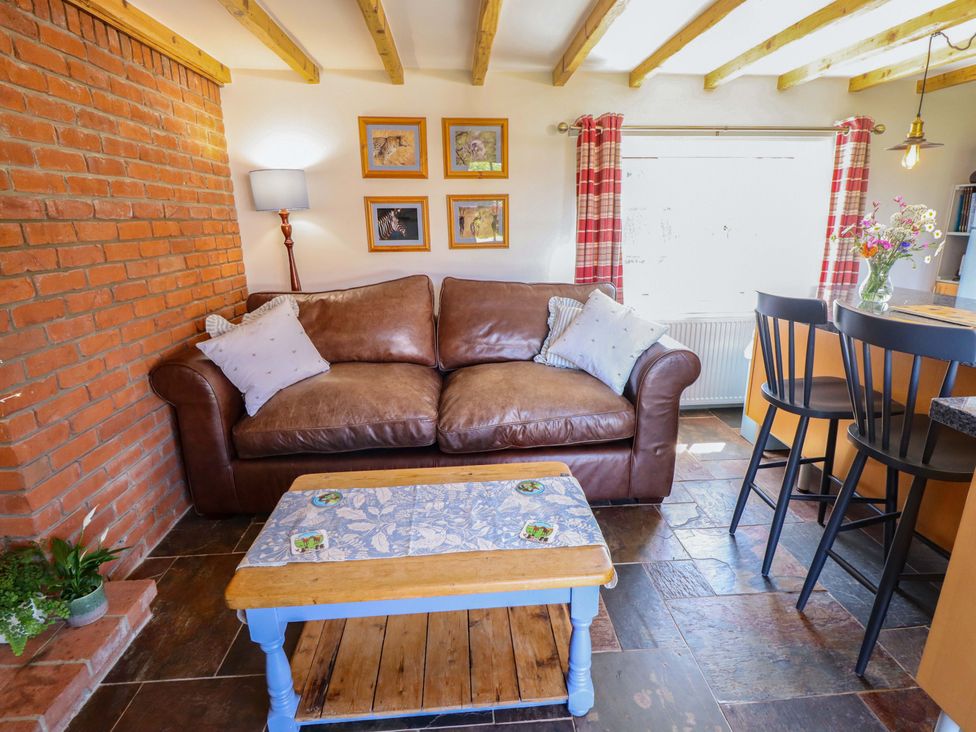 A living room with a sofa and coffee table at Gables Cottage Market Rasen