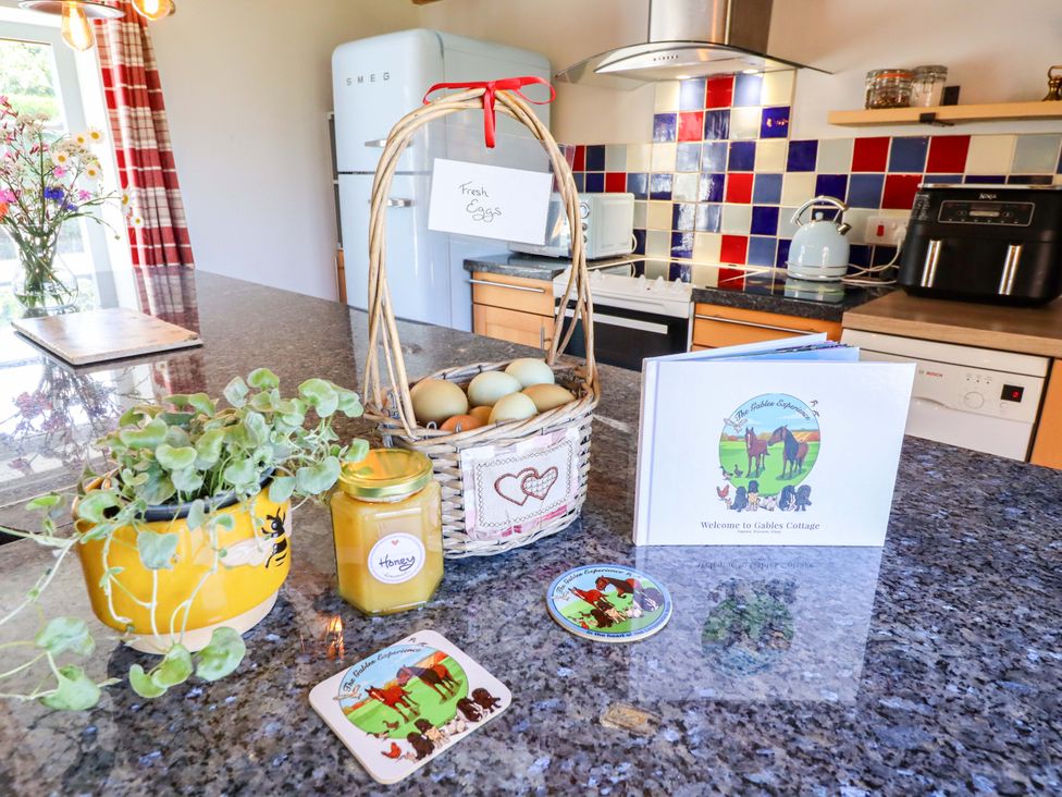 A kitchen with eggs in a basket and a honey jar at Gables Cottage Market Rasen