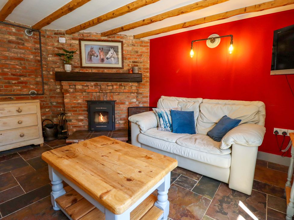 A living room with a sofa and coffee table at Gables Cottage in Market Rasen