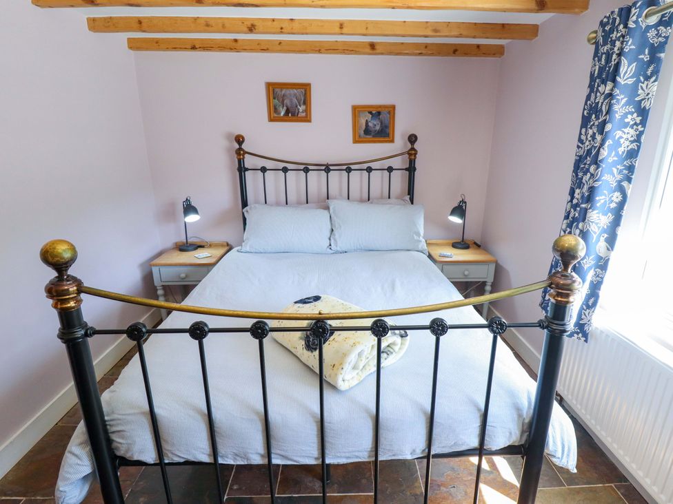 A bedroom with a bed and bedside lamps at Gables Cottage Market Rasen