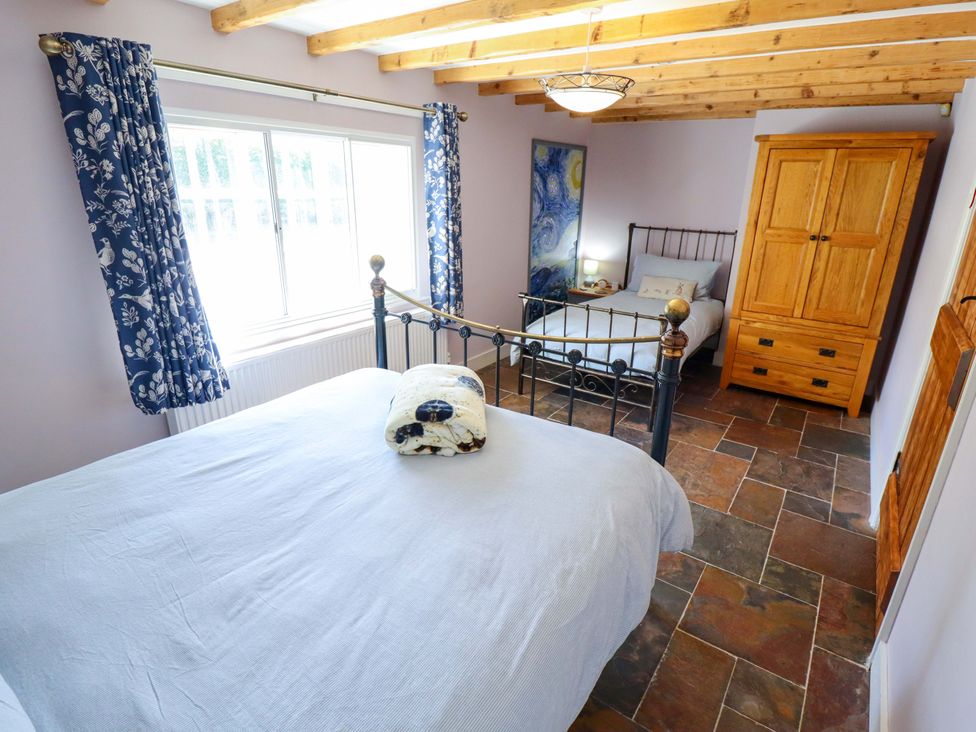 A bedroom with a double and single bed at Gables Cottage in Market Rasen