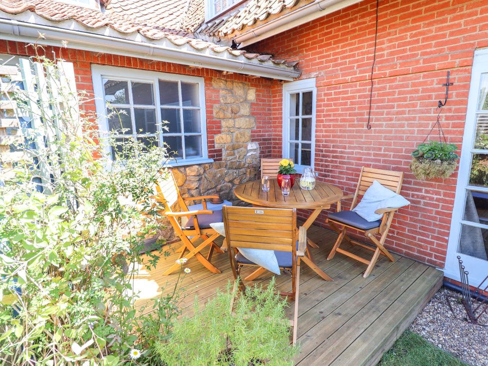 A patio area with a table and chairs at Gables Cottage Market Rasen
