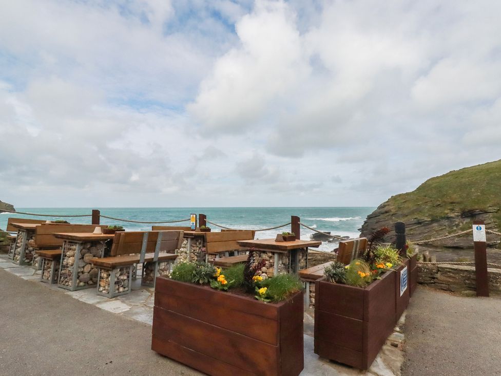 An outdoor seating area overlooking the sea at Smugglers Cottage Trebarwith Strand near Tintagel