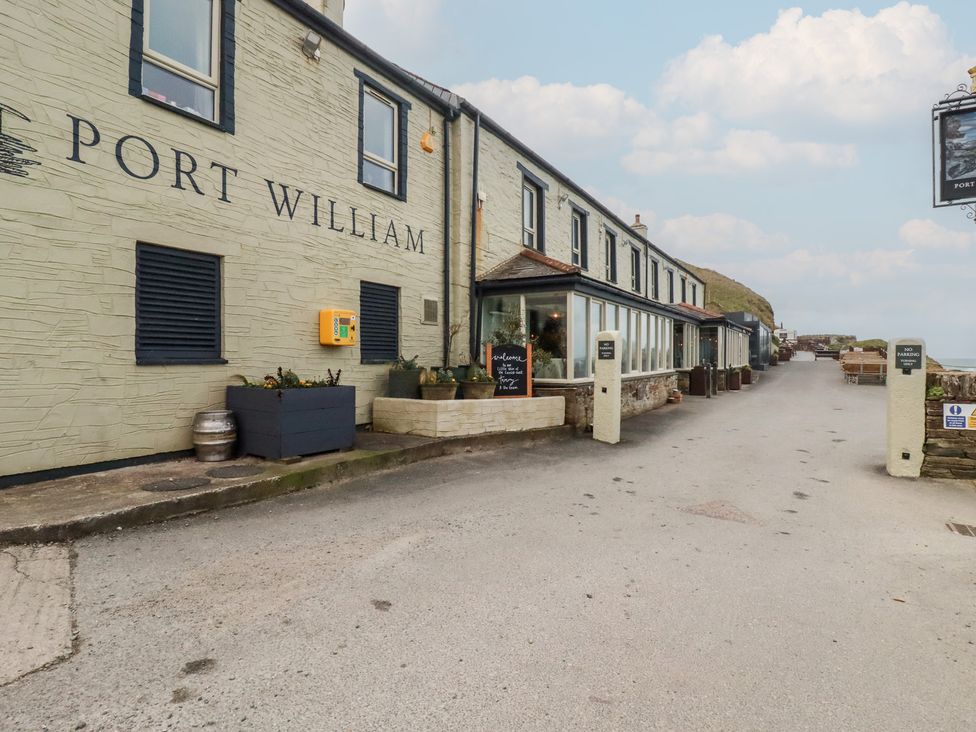 An exterior view of Port William building with planters in Trebarwith Strand near Tintagel