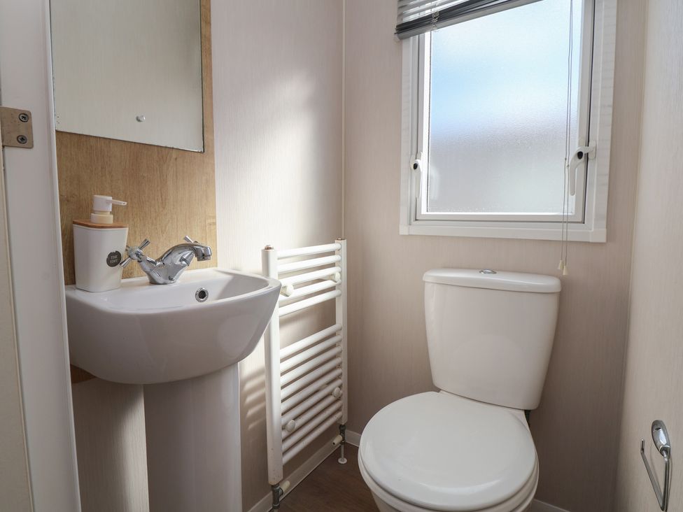 A bathroom with a sink and toilet at K2 Static Caravan