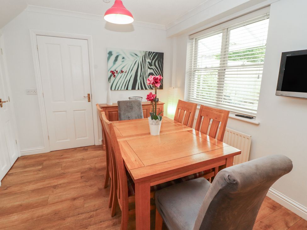 A dining room with a table and chairs at Riverside Cottage in Cockermouth