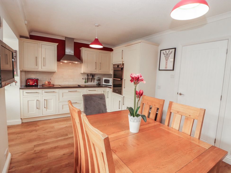 A kitchen with a dining table and chairs at Riverside Cottage in Cockermouth