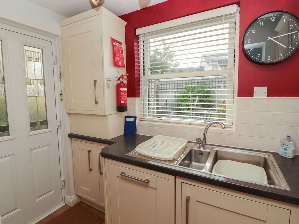A kitchen with sink and dish rack at Riverside Cottage in Cockermouth