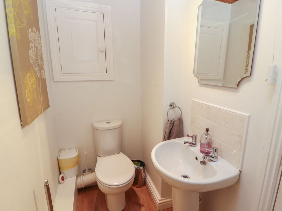 A bathroom with a toilet and sink at Riverside Cottage in Cockermouth
