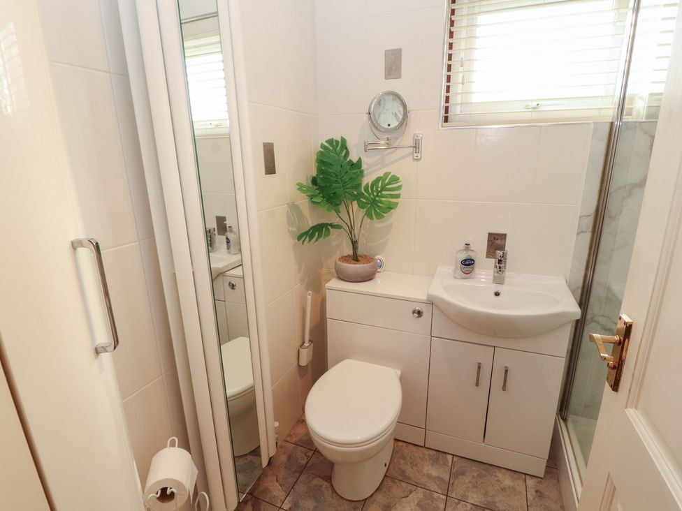 A bathroom with a toilet and sink at Riverside Cottage in Cockermouth