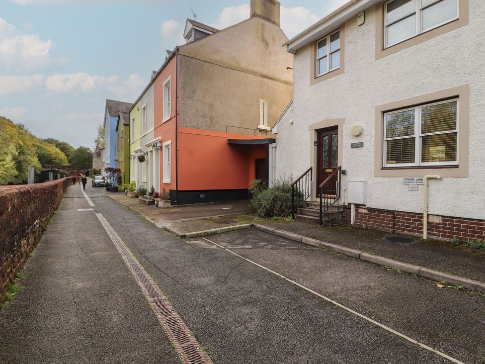 A street with houses and a sidewalk at Riverside Cottage Cockermouth