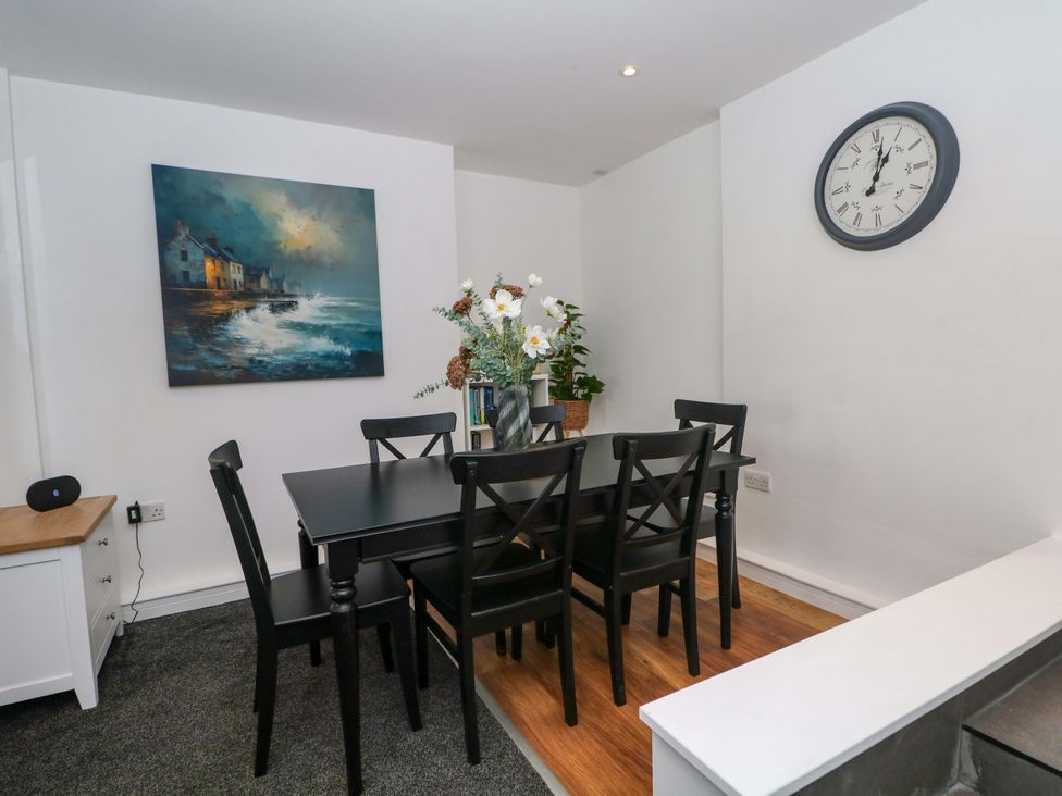 A dining room with a table and chairs at Broad Beams Parkgate near Neston